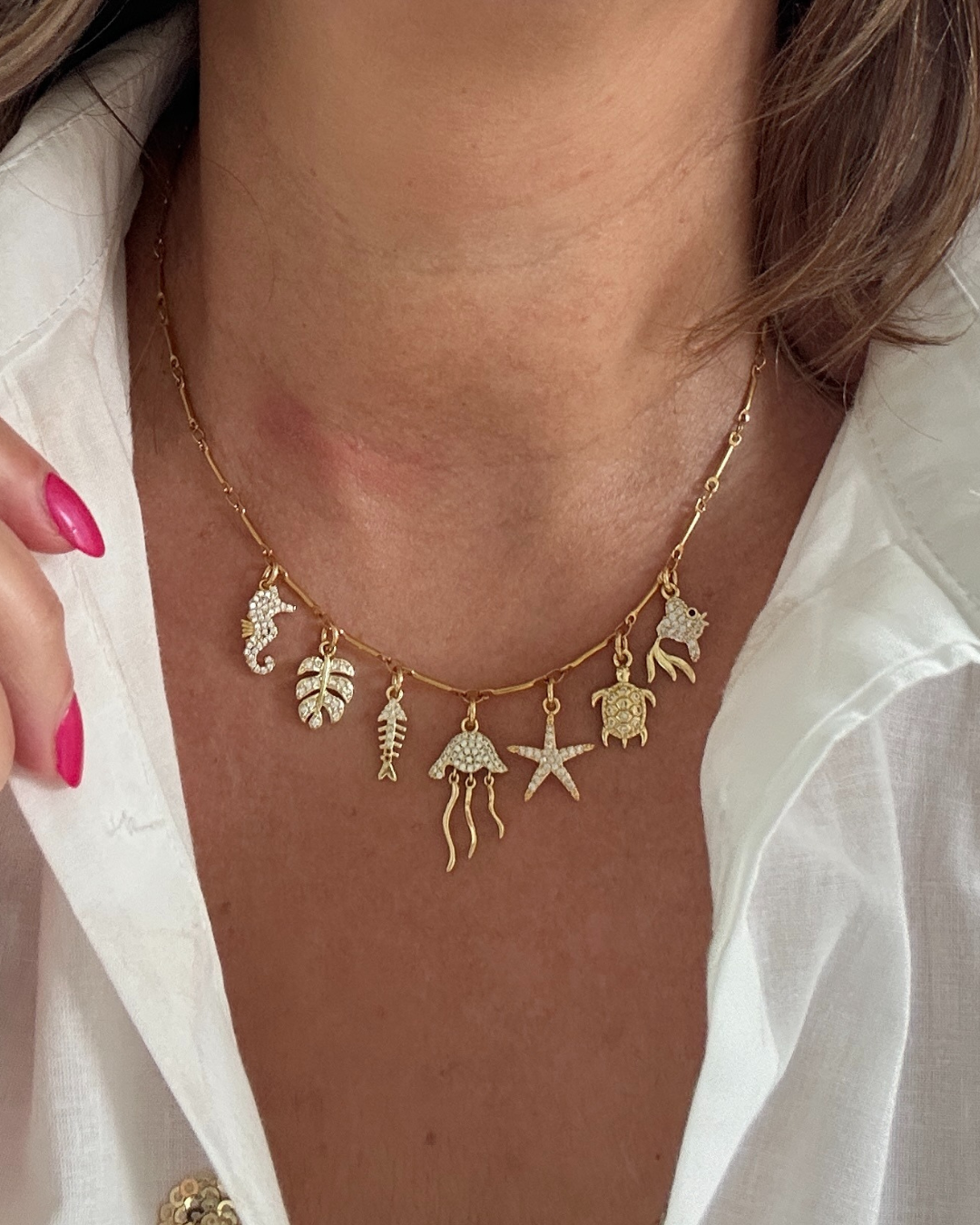 Laat je verleiden door de fonkeling van de zee.
Deze elegante gouden bedelketting is een ode aan zon, zee en zomerse charme. Met schitterende zirkonia bedels in de vorm van schelpjes, visjes, zeesterren, en alles wat er in de zee te vinden is, vangt deze ketting de magie van de oceaan in elke beweging.
Een stijlvolle eyecatcher die moeiteloos aansluit bij de trends van nu, en jouw look direct een sprankelende, zomerse upgrade geeft.