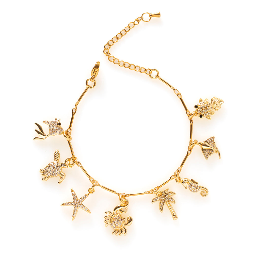 Sea Story brengt de rust en schoonheid van de zee samen in één elegante bedelarmband. Deze handgemaakte armband is afgewerkt met fonkelende zirkonia bedels van een visje, schildpad, zeester, krab, palmboom, zeepaardje, rog en vis.
Elke bedel staat symbool voor zomerse dagen aan zee, vrijheid en bijzondere herinneringen. De verfijnde details en subtiele glans geven de armband een tijdloze uitstraling, waardoor je hem moeiteloos combineert met andere sieraden of juist als blikvanger draagt.