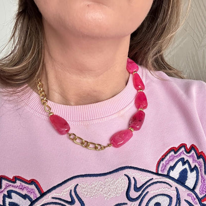Deze grove schakelketting met gemarmerde fuchsia acryl kralen is een echte eyecatcher. De chunky schakels geven de ketting een stoer en trendy karakter, terwijl de fuchsia marmerlook zorgt voor een speelse en luxe uitstraling.

Perfect om een blouse direct meer power te geven, maar ook verrassend mooi op een warme trui. Deze ketting is gemaakt voor vrouwen die durven op te vallen en hun outfit moeiteloos naar een hoger niveau tillen. Trendy, opvallend en veelzijdig – precies wat een statement accessoire moe