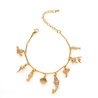 Laat je meenemen op een zomers avontuur met Seaside Story! Deze goudkleurige bedelarmband met visjes, een schelpje en een zeepaardje fonkelt speels dankzij de zirkonia steentjes. Vrolijk, stijlvol en klaar om jouw zomeroutfit compleet te maken.