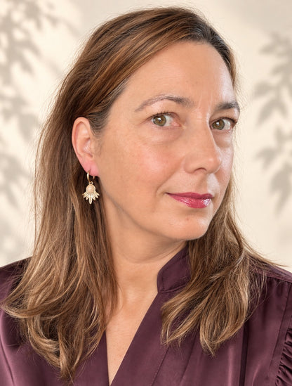 Geef je look een zachte, warme glans met de Rose Dawn oorbellen. Een ronde rozenkwarts in zacht roze rust op een gouden waaier van fijn bewerkte blaadjes, gedragen door een dunne klapcreool. De subtiele kleur van de steen contrasteert mooi met het goud en maakt de oorbellen verfijnd zonder in te boeten aan uitstraling, Tijdloos, perfect voor dagelijks gebruik of een avondje uit.