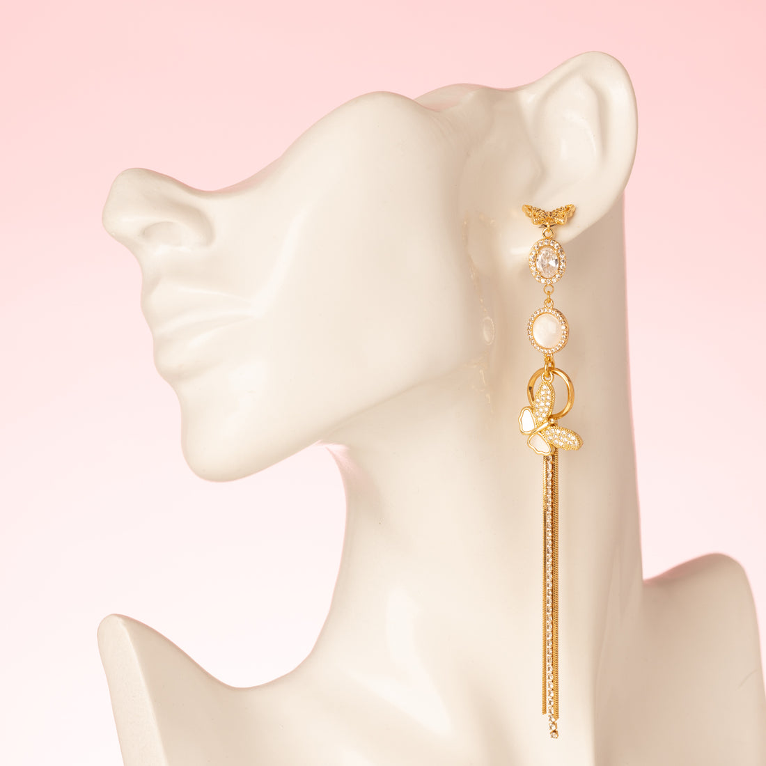 Deze prachtige asymmetrische oorbellen zijn een waar statement. De stekers zijn in de vorm van een elegante vlinder, die een verfijnde en delicate uitstraling geeft. De oorbellen zijn verder versierd met schitterende zirkonia en parelmoer stenen, wat zorgt voor een luxe en sprankelend effect. Een subtiele fringe van zirkonia steentjes voegt een speels en sierlijk element toe aan het geheel.